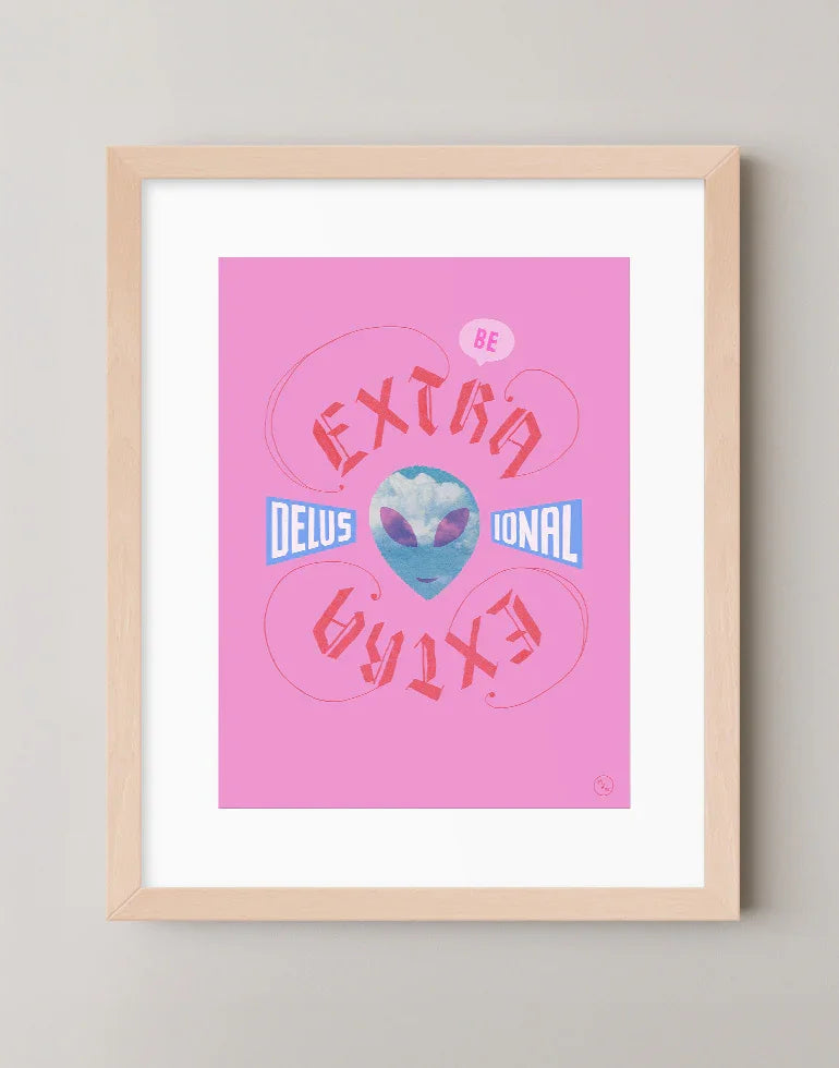 Extra Delusional pink and blue blackletter calligraphy art print featuring an alien face with clouds in a warm maple frame.
