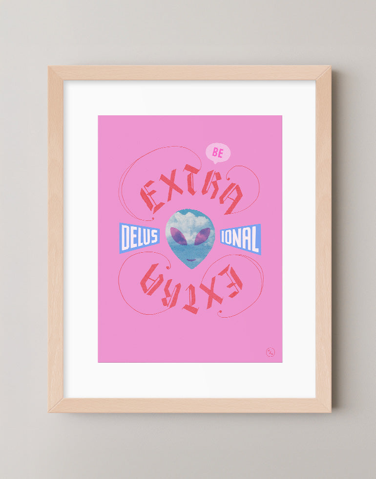 Extra Delusional pink and blue blackletter calligraphy art print featuring an alien face with clouds in a warm maple frame.